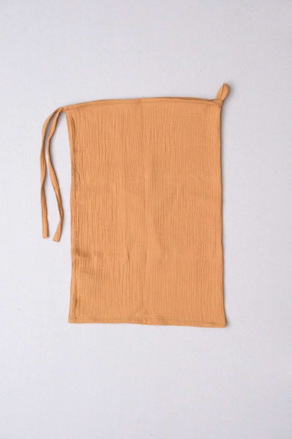 flatlay of the muslin gauze cotton dishtowel in Honey by the brand Cats and Boys