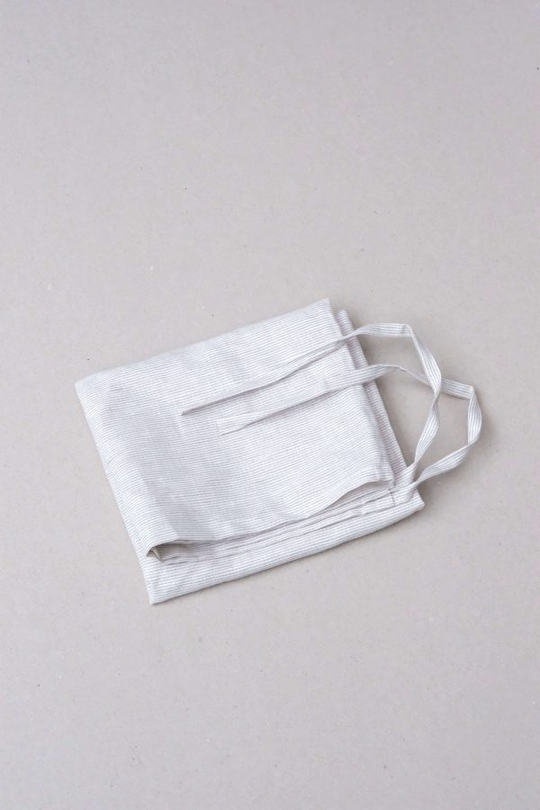 flatlay of the linen dishtowel in Natural Stripes by the brand Cats and Boys