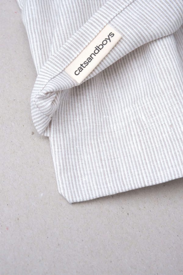 flatlay of the linen pillowcase in natural stripes by the brand Cats and Boys