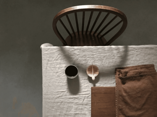 the linen table cloth in off-white by the brand Cats and Boys