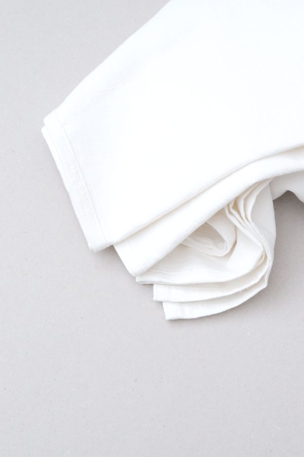 flatlay of the linen table cloth in off-white by the brand Cats and Boys