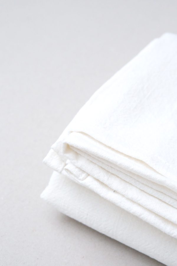 flatlay of the linen table cloth in off-white by the brand Cats and Boys