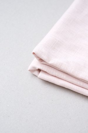 flatlay of the linen table cloth in pale pink by the brand Cats and Boys