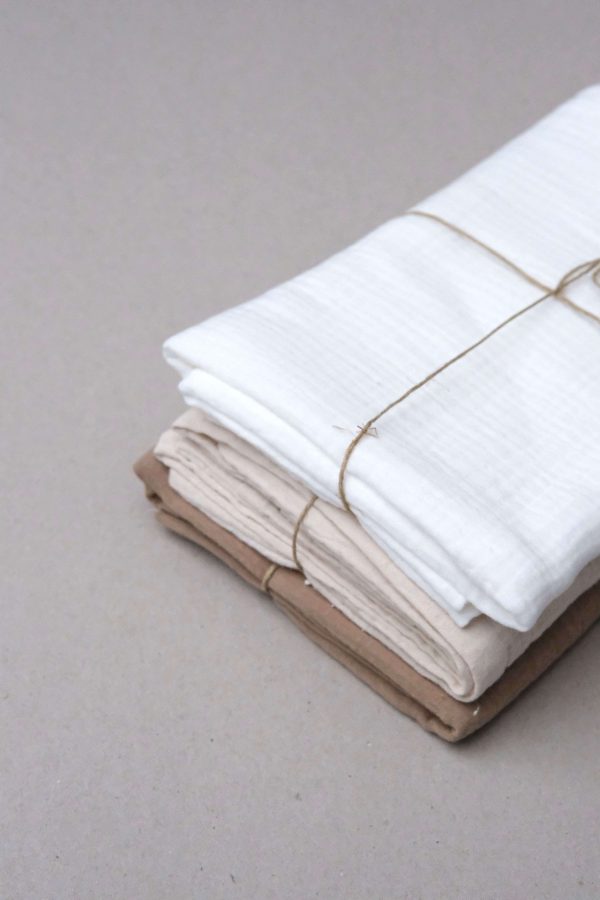 flatlay of the muslin cotton gauze Pillowcase in Caramel, Natural & Milk by the brand Cats and Boys
