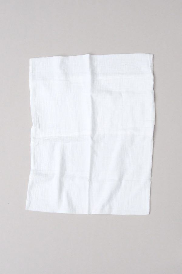 flatlay of the muslin cotton gauze Pillowcase in Milk by the brand Cats and Boys