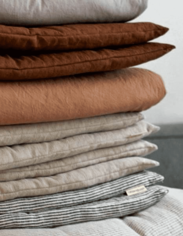 the linen topstitched quilt in almond & stripes by the brand Cats and Boys