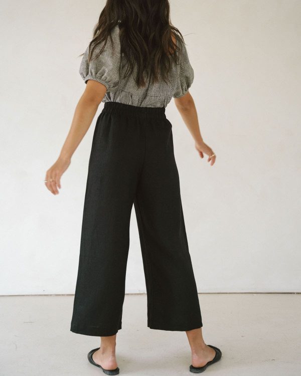 woman wearing the linen Aura Pants in Black by the brand Harly Jae