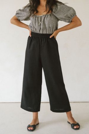 woman wearing the linen Aura Pants in Black by the brand Harly Jae