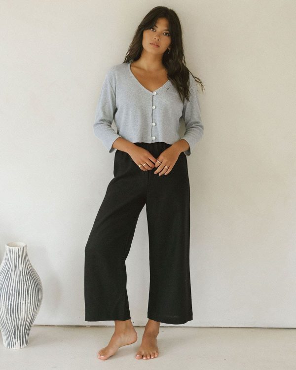 woman wearing the linen Aura Pants in Black paired with the James Blouse by the brand Harly Jae