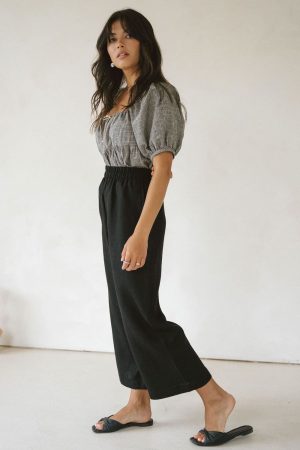 woman wearing the linen Aura Pants in Black by the brand Harly Jae