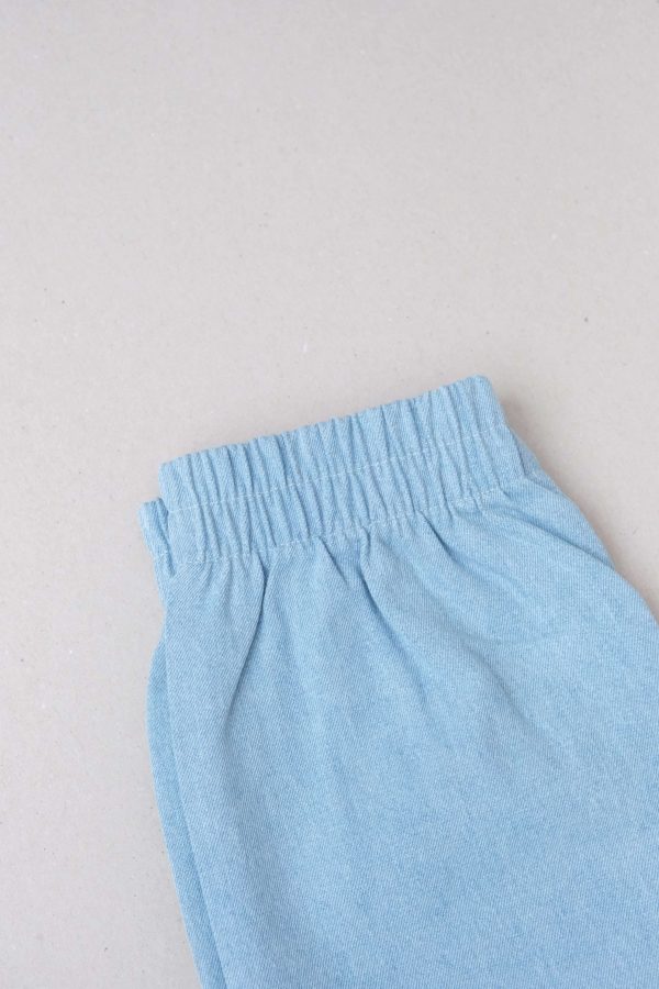 flatlay of the cotton Aura Pants in Light Denim by the brand Harly Jae