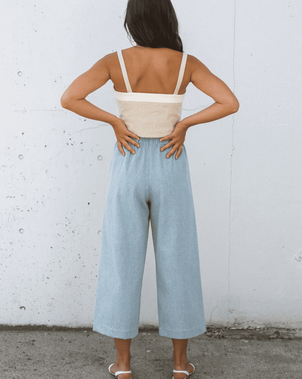 woman wearing the cotton Aura Pants in Light Denim by the brand Harly Jae