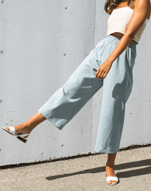 woman wearing the cotton Aura Pants in Light Denim by the brand Harly Jae