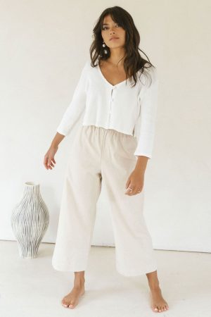 woman wearing the organic/linen Aura Pants in Natural paired with the James Blouse by the brand Harly Jae