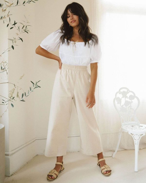 woman wearing the organic/linen Aura Pants in Natural by the brand Harly Jae