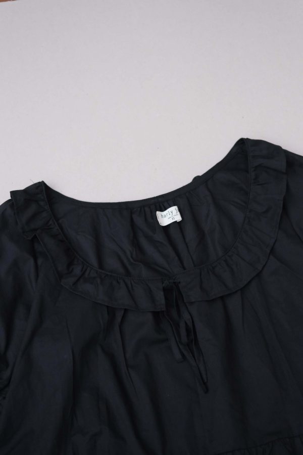 flatlay of the organic cotton Doll Blouse in Black by the brand Harly Jae