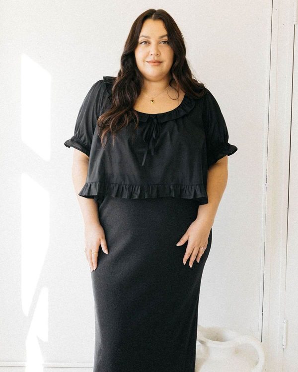 woman wearing the organic cotton Doll Blouse in Black by the brand Harly Jae