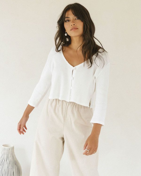 woman wearing the organic cotton waffle James Blouse in White paired with the Aura Pants by the brand Harly Jae