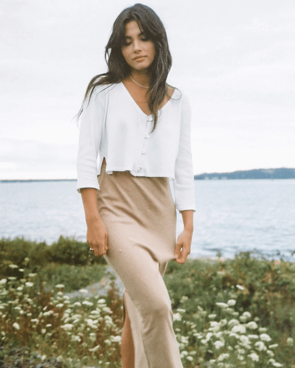 woman wearing the organic cotton waffle James Blouse in White paired with the Kea Skirt by the brand Harly Jae