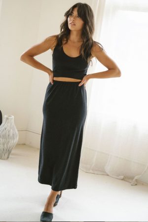 woman wearing the organic cotton Kea Skirt in Black by the brand Harly Jae