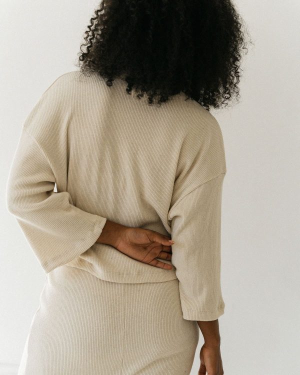 woman wearing the organic hemp & cotton Kea Skirt & Porto Henley in Off-White by the brand Harly Jae