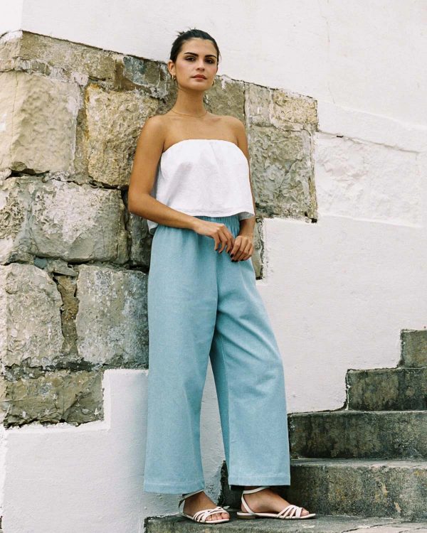 woman wearing the Aura Pants in light denim cotton by the sustainable brand Harly Jae, curated by Morsel Store