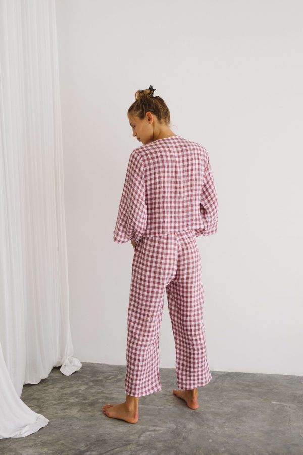 woman wearing the Mia Pants & Mia Wrap Top in Cherry Gingham by the brand The Bare Road