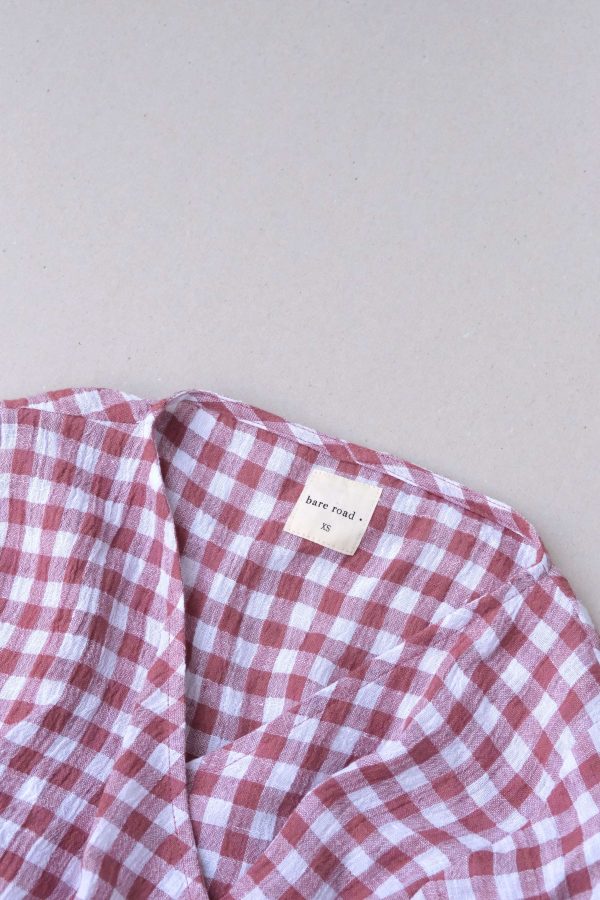 the Mia Wrap Top in Cherry Gingham by the brand The Bare Road
