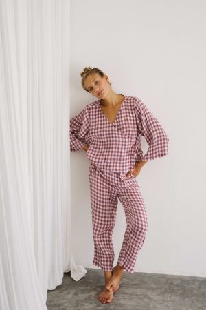 woman wearing the Mia Wrap Top & Mia Pants in Cherry Gingham by the brand The Bare Road