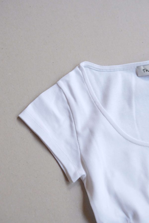 flatlay of the Emma Tee in White by the brand The Sept