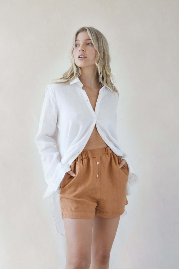 woman wearing the Gabrielle Shorts in Caramel by the brand The Sept