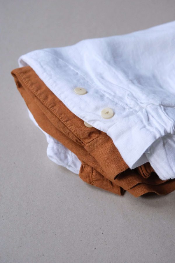 flatlay of the Gabrielle Shorts in White and Caramel by the brand The Sept