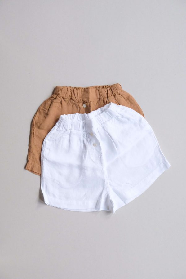 flatlay of the Gabrielle Shorts in White and Caramel by the brand The Sept