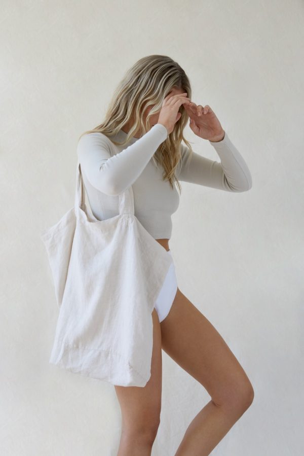 woman wearing the Lua Bag in Natural by the brand the Sept