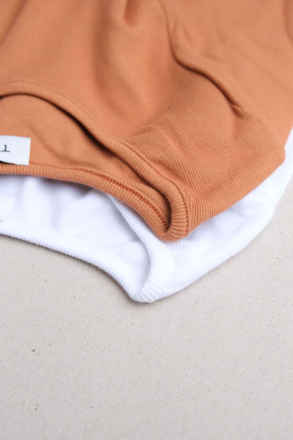 flatlay of the Mel Longsleeve in white & caramel by the brand The Sept