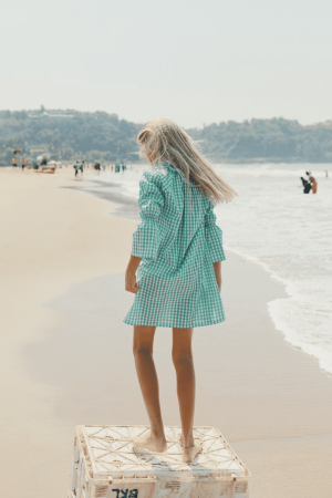 the Dalia Dress in Apple Plaid by the brand Yoli & Otis