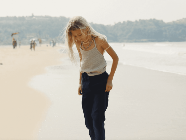 the Hassan Trousers in Navy paired with the Ami Halter Top by the brand Yoli & Otis
