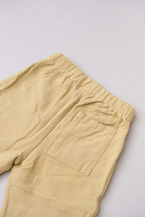 the Hassan Trousers in Parsnip by the brand Yoli & Otis