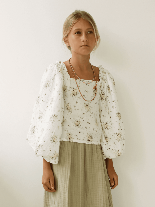 the Louilian blouse in Vintage Floral paired with the Claudia Skirt by the brand Yoli & Otis