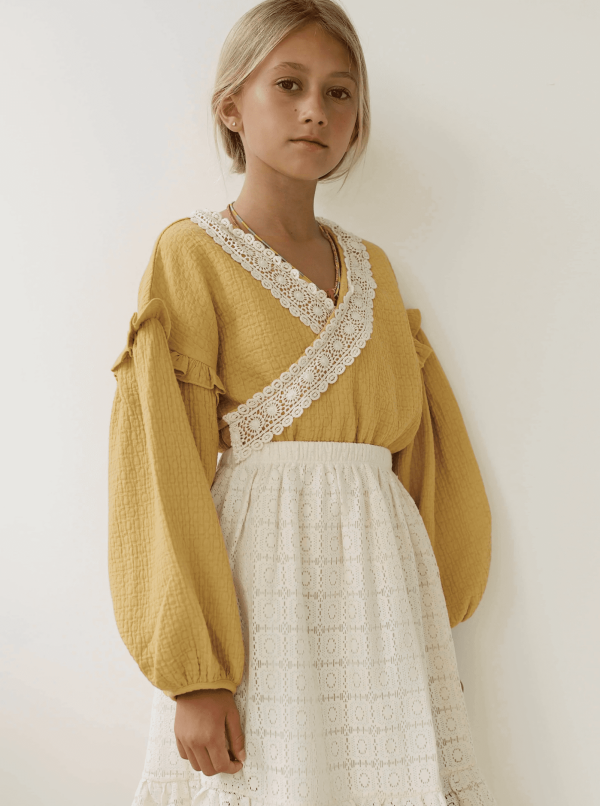 the Rauf Top in Parsnip paired with the Claudia Skirt by the brand Yoli & Otis