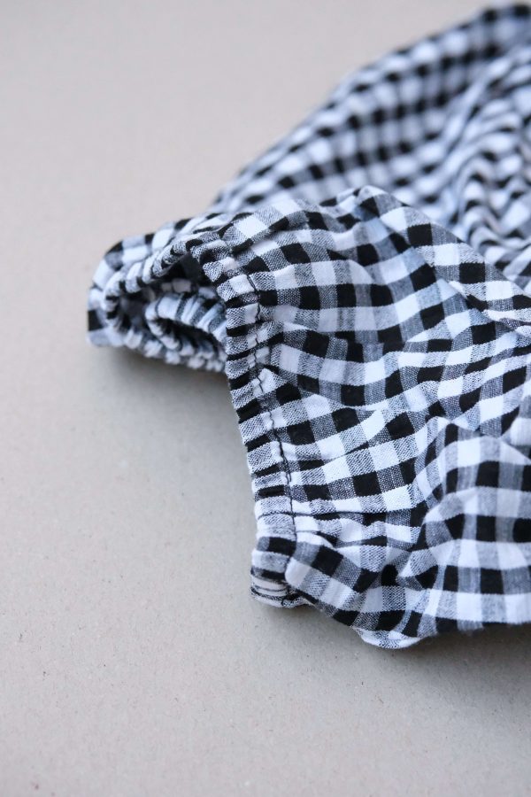 the Ella Wrap Top in Black Gingham by the brand The Bare Road