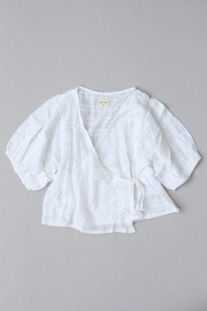 the Ella Wrap Top in White Textured by the brand The Bare Road