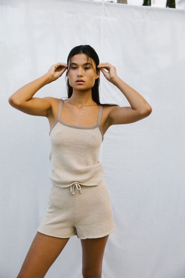 woman wearing the Emma Knit Shorts & Singlet in Bone by the brand The Bare Road