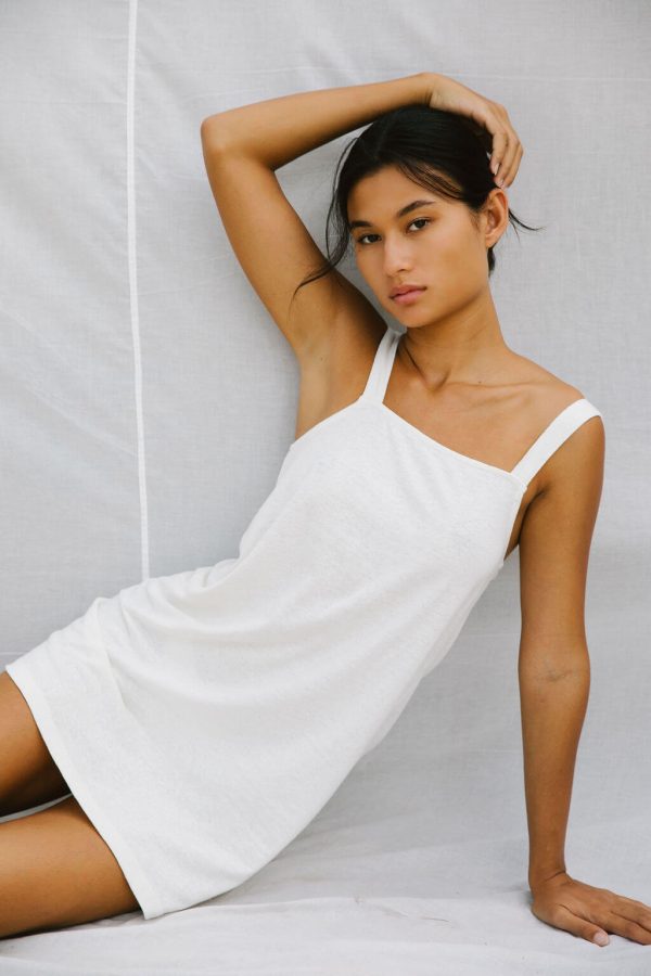woman wearing the Sunny Hemp Dress in White by the brand The Bare Road