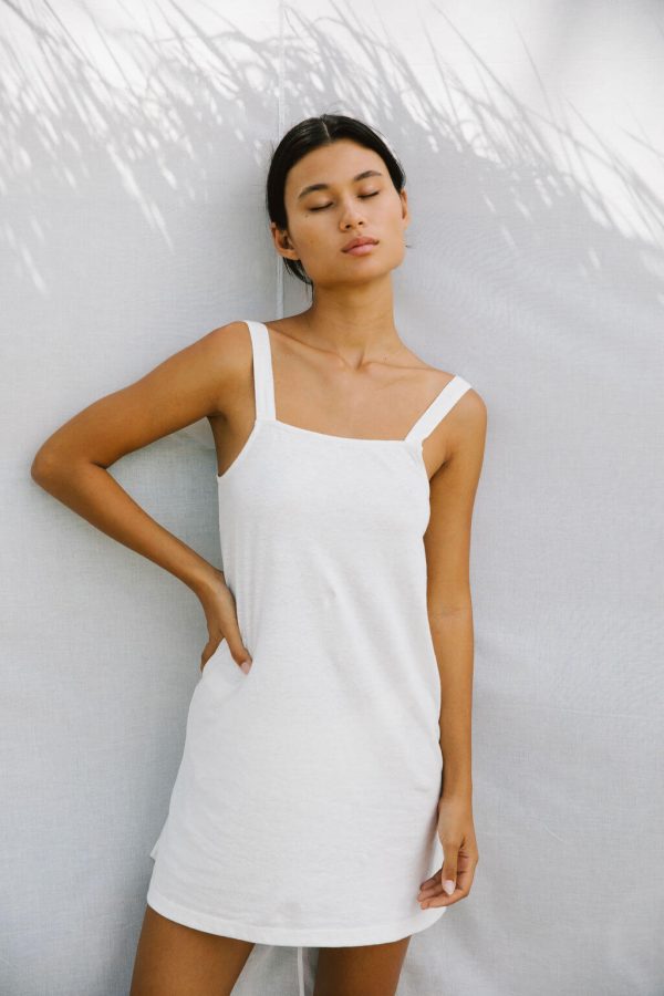 woman wearing the Sunny Hemp Dress in White by the brand The Bare Road