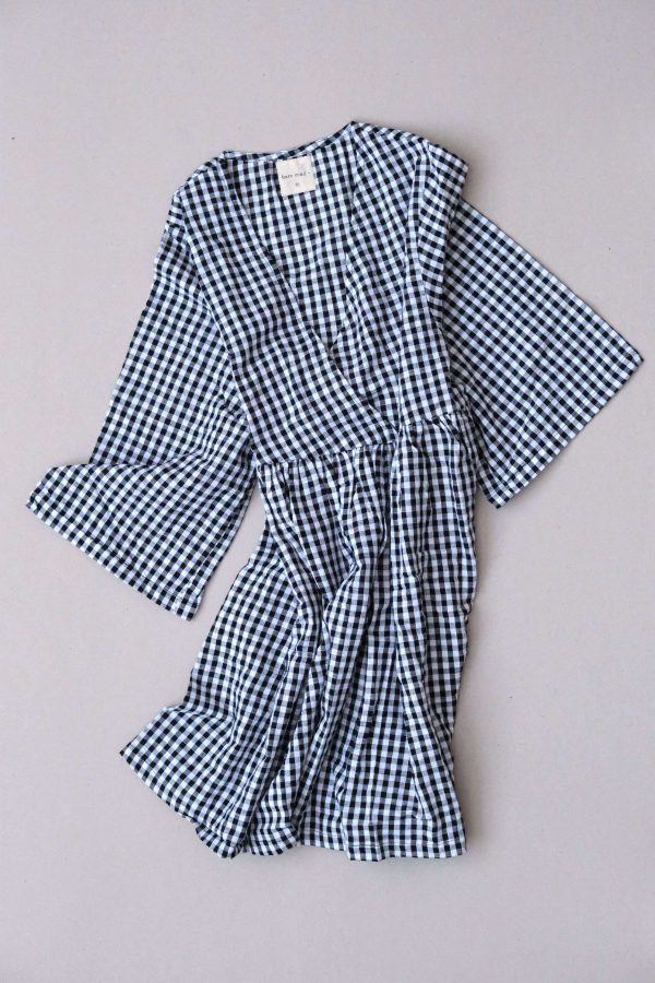 the Holiday Wrap Dress in Black Gingham by the brand The Bare Road