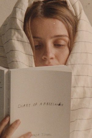 woman reading the Diary of a Freelancer book by Amanda Jones