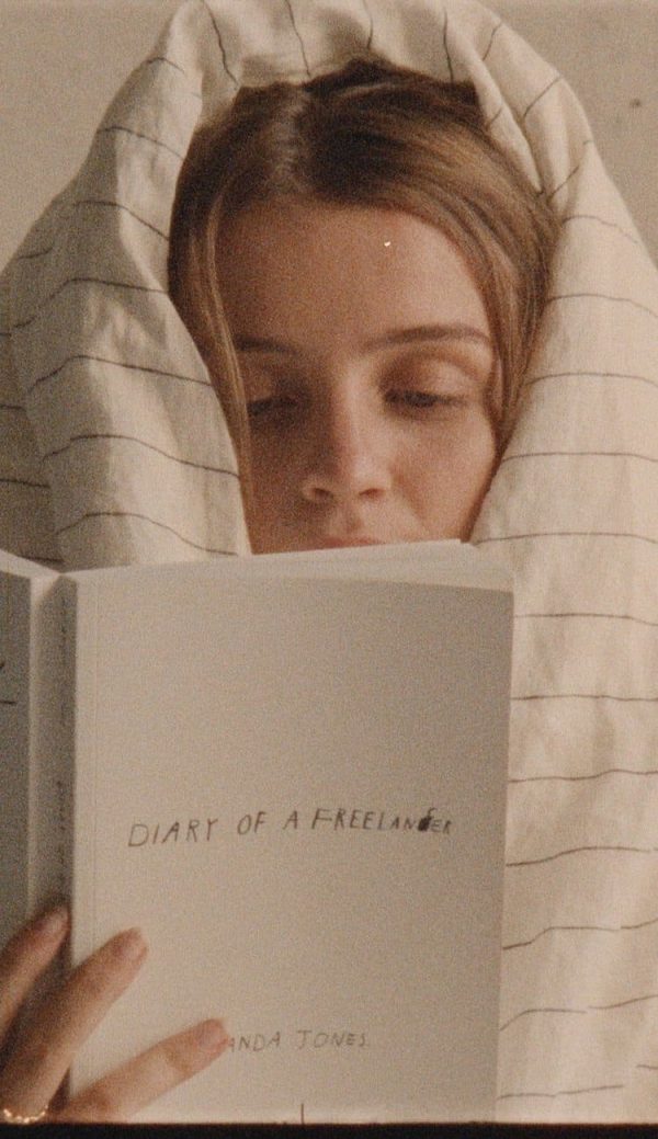 woman reading the Diary of a Freelancer book by Amanda Jones