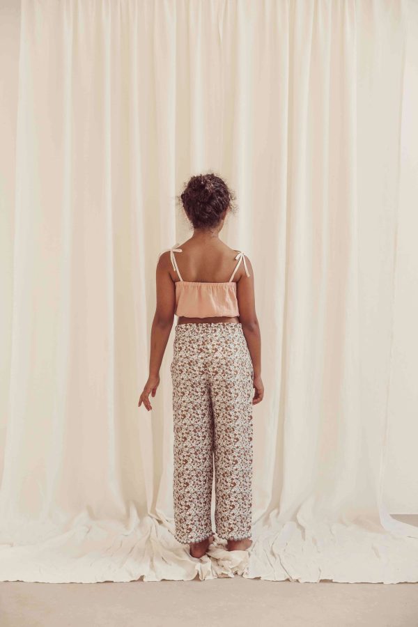 the organic cotton Claudia Pants in field flowers paired with the Susa Top in Peach by the brand LiiLU