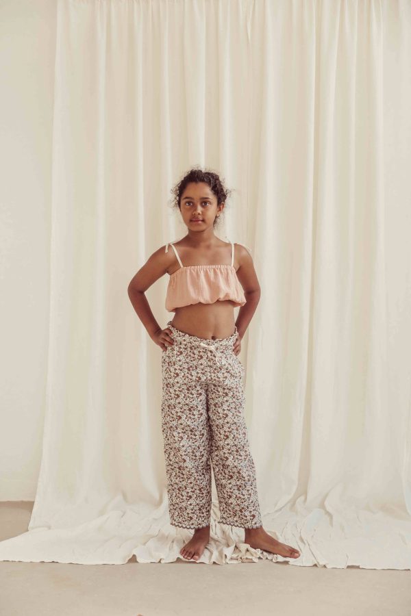 the organic cotton Claudia Pants in field flowers paired with the Susa Top in Peach by the brand LiiLU